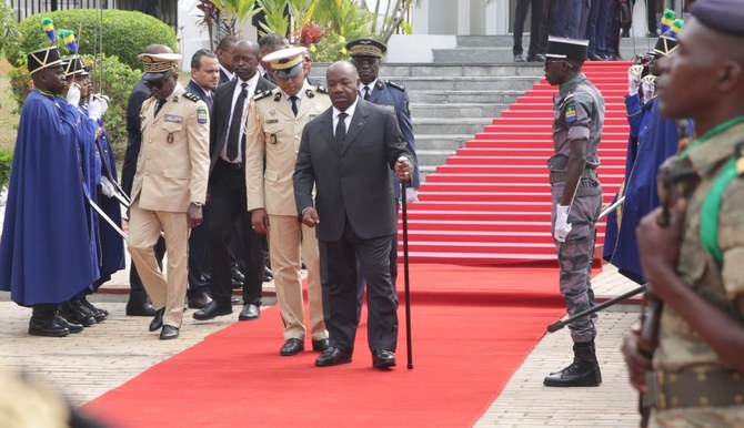 President Ali Bongo (center) reviews troops in August 2019 after his convalescence (AFP)