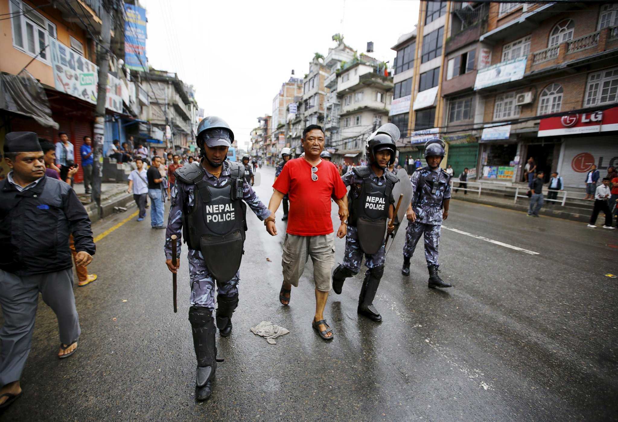 Nepalese police officers detaining a protester in Kathmandu on Sunday. Members of the Tharu ethnic group have rebelled against a  draft constitution that does not establish a separate territory for them [photo credit: Reuters]