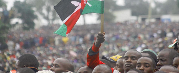 A Kenya Citizen raise a flag during the signing of the new constitution into law, at Uhuru Park in Nairobi, Kenya, Friday, Aug. 27, 2010. African leaders including Rwanda's Paul Kagame joined tens of thousands of Kenyans Friday as a new constitution was signed into law.PHOTO BY TOM MARUKO PHOTO BY TOM MARUKO