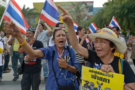 Anti-government protesters shout slogans as they gather at in front of the Constitutional Court in Bangkok on November 20, 2013. (Credit: AFP) Anti-government protesters shout slogans as they gather at in front of the Constitutional Court in Bangkok on November 20, 2013. (Credit: AFP)
