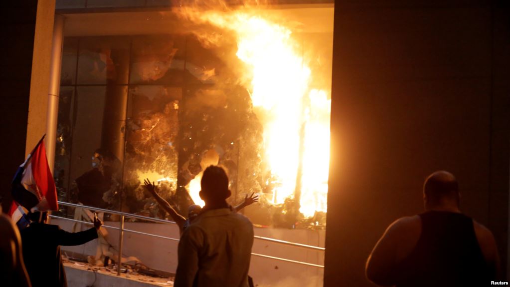 Protestors set fire to the Congress building during a demonstration against a possible change in the law to allow for presidential re-election (Photo credit: USA Today)