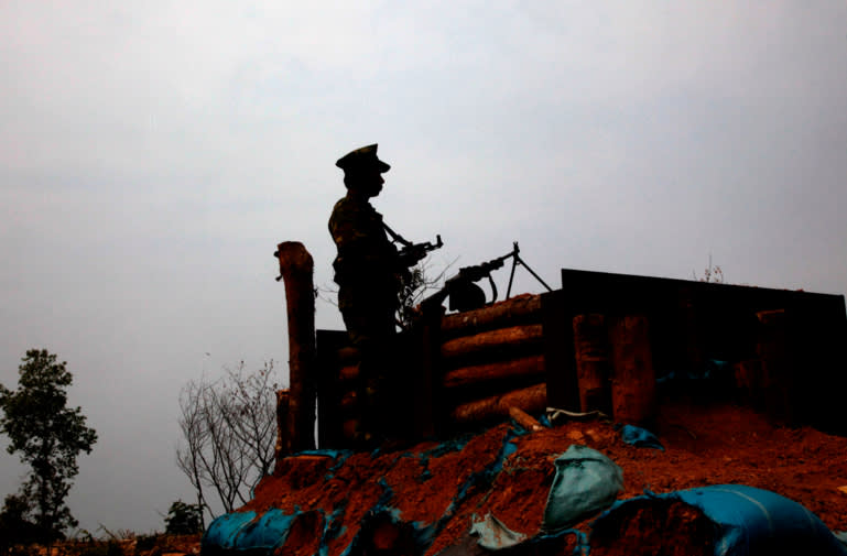 A Kachin Independence Army rebel stands guard at an outpost in the northern state of Kachin (photo credit: AP) A Kachin Independence Army rebel stands guard at an outpost in the northern state of Kachin (photo credit: AP)