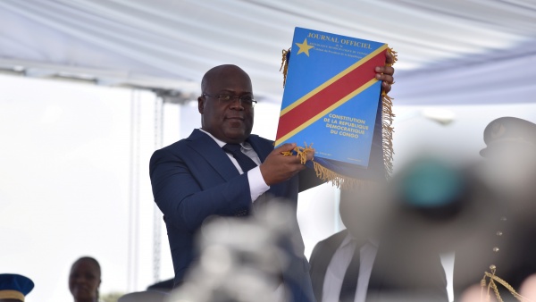 Tshisekedi holds constitution during his inauguration (photo credit: Olivia Acland/Reuters)
