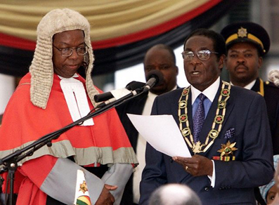 Zimbabwean president Robert Mugabe swearing in before the Chief Justice (photo credit: JJ McCullough)