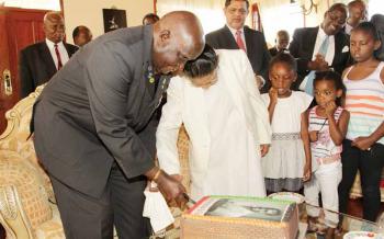 Dr Kaunda and Dr Rajan Mahtani's mother Mohini cut a birthday cake while his granddaughter Sonji (r) and great granddaughters Michelle and Tiyezye look on at a party organised for him by the Mahtani Group of Companies yesterday - Picture by Salim Dawood Picture by Salim Dawood