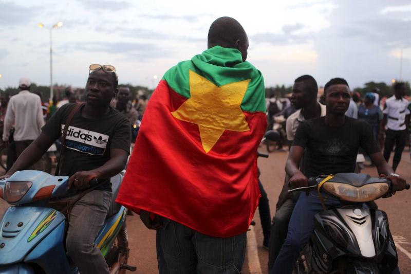 A protester wearing a Burkina Faso flag attends a protest against the presidential guard in Ouagadougou, Burkina Faso, September 16, 2015 [photo credit: Reuters]