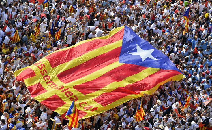 Demonstrators hold pro-independence flag on Catalonia's National Day(photo credit: Gerard Julien/AFP)