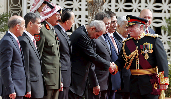 Jordan's King Abdullah shakes hands as he arrives for the opening of the third ordinary session of the 17th parliament  (photo credit: REUTERS/Muhammad Hamed)