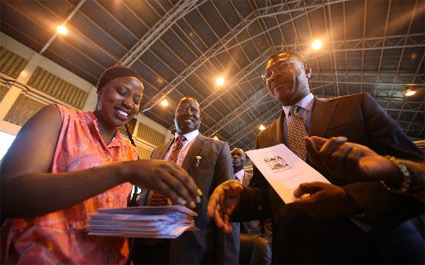 Ms Adhiambo Opondo (left) gives Cord co-principal Moses Wetangula a booklet, as Cord leader Raila Odinga (centre) looks on at Bomas of Kenya in Nairobi on April 23, 2015 after the launch of 'Okoa Kenya' Bill (photo credit: Evans Habil/Nation Media Group)