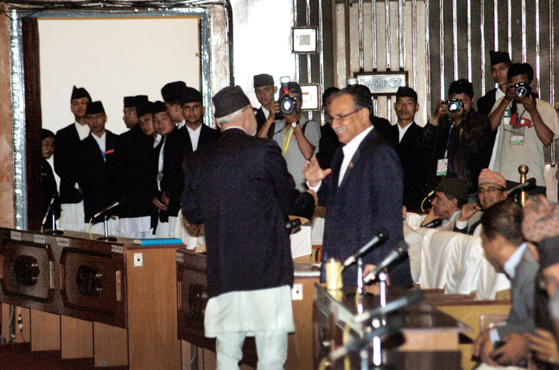 Sushil Koirala and Pushpa Kamal Dahal greeting each other as the CA puts amendment proposals to vote on Sunday [photo credit: The Himalayan Times]