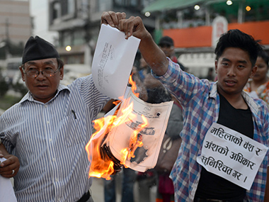 Nepali activists burn a copy of the draft constitution (photo credit: AFP) Nepali activists burn a copy of the draft constitution (photo credit: AFP)