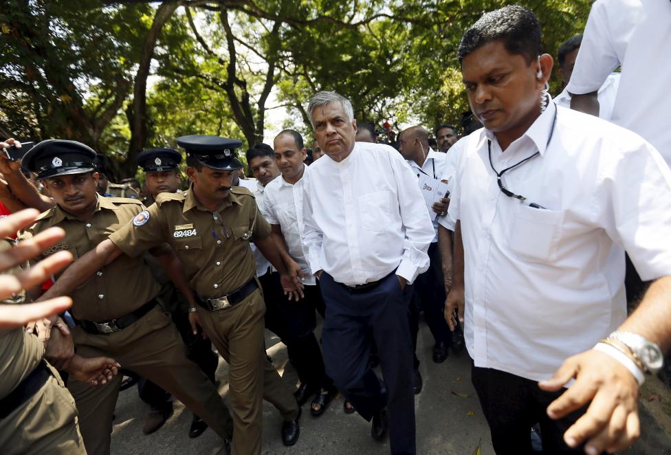 Sri Lanka's Prime Minister Ranil Wickremesinghe (C) arrives at a polling station during a general election in Colombo, August 17, 2015 [photo credit: Reuters]