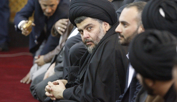 Iraqi Shiite cleric Muqtada al-Sadr (C) takes part in Friday prayers at the Abdu