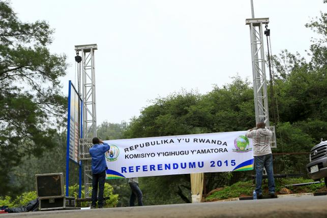 People erect a banner at the entrance of a polling station on the eve of a referendum as Rwandans will vote to amend its Constitution to allow President Paul Kagame to seek a third term in Rwanda capital Kigali, December 17, 2015. (photo credit: Reuters) People erect a banner at the entrance of a polling station on the eve of a referendum as Rwandans will vote to amend its Constitution to allow President Paul Kagame to seek a third term in Rwanda capital Kigali, December 17, 2015. (photo credit: Reuters)