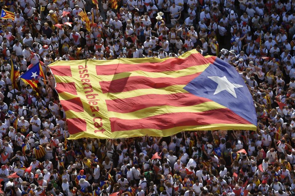 Demonstrators unfold an "Estelada" (pro-independence Catalan flag) during celebrations for Catalonia's National Day in Barcelona on September 11, 2015 (photo credit: AFP)