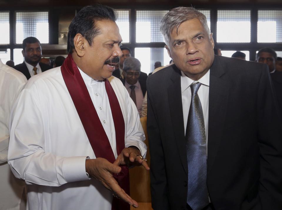 Sri Lanka’s Prime Minister Ranil Wickremesinghe, right, listens to former president Mahinda Rajapaksa after the first meeting of the members of parliament since the election on Aug. 17, in Colombo, Sri Lanka, Tuesday, Sept. 1, 2015 [photo credit: AP]