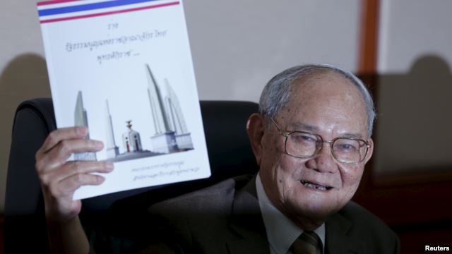 Meechai Ruchupan, head of Thailand's Constitution Drafting Committee, holds up a draft constitution (photo credit: Reuters)