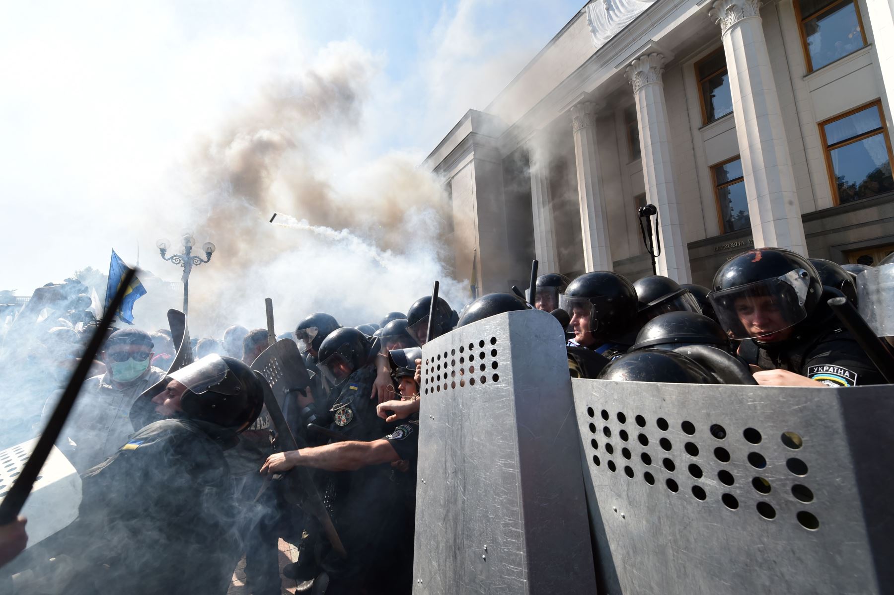 Smoke rises from the parliament building in Kiev as activists from radical Ukrainian parties, including the nationalist Svoboda, clash with police [photo credit: AFP]